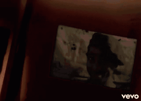 a picture of tupac shakur is being projected onto a wall .