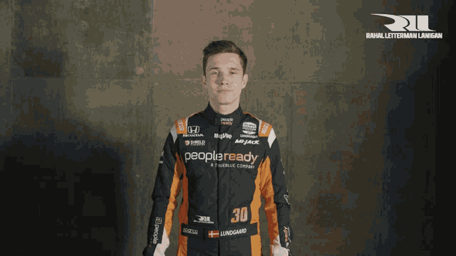 a man in a racing suit with the number 30