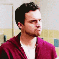 a man with a beard is making a funny face while wearing a purple jacket .