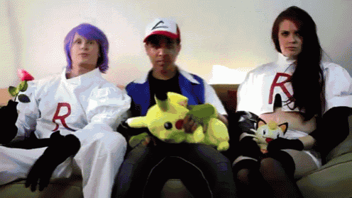 a group of people dressed in pokemon costumes are sitting on a couch holding stuffed pokemon