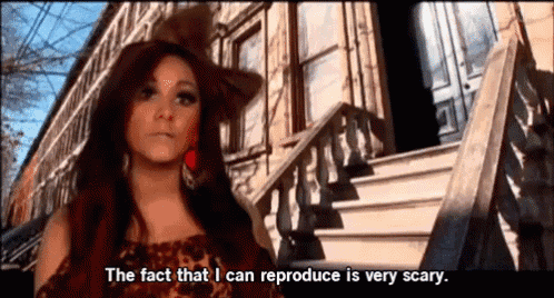 a woman in a hat says the fact that i can reproduce is very scary in front of a building