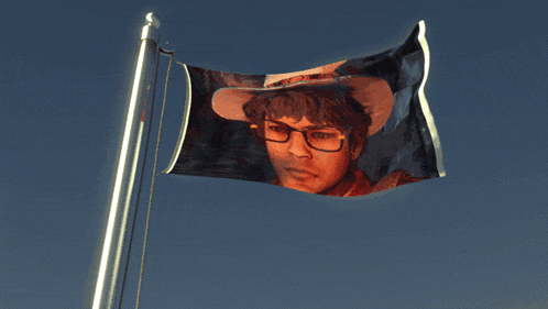 a flag with a picture of a man in a cowboy hat