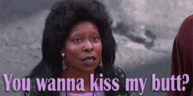 a woman is saying `` you wanna kiss my butt '' while standing next to a man .