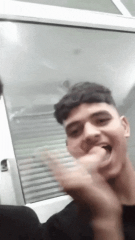a young man is making a funny face with his mouth open