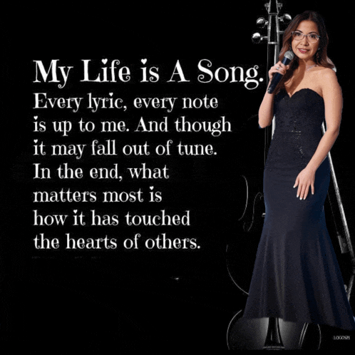 a woman in a black dress singing into a microphone