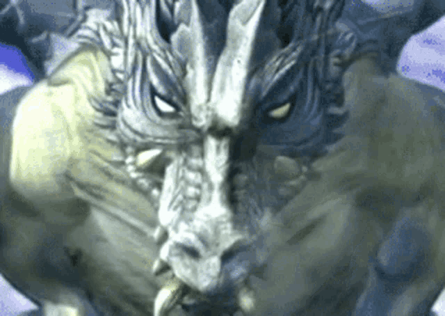 a close up of a statue of a monster with horns and teeth