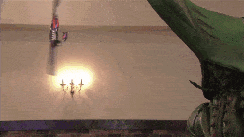 a statue of a dragon is hanging from a ceiling next to a light