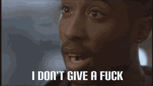 a close up of a man 's face with the words " i don 't give a fuck " above him