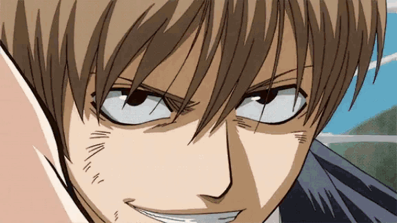 a close up of a man 's face with a slight smile on his face