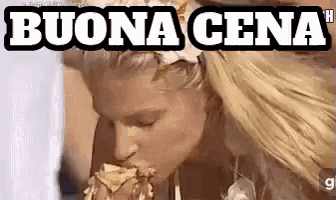 a woman is eating a large piece of food with the words buona cena written above her .