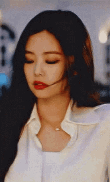 a close up of a woman wearing a white shirt and red lips