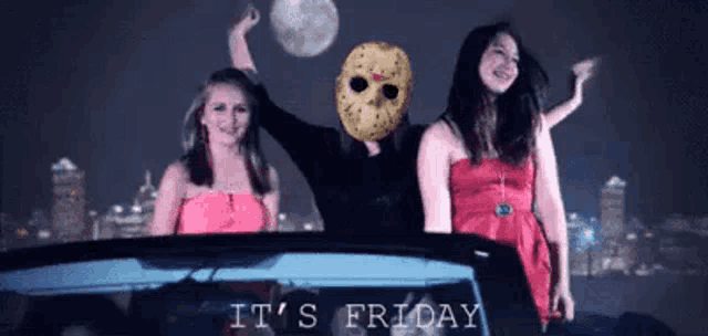 a man in a jason voorhees mask is surrounded by two women in a car ..