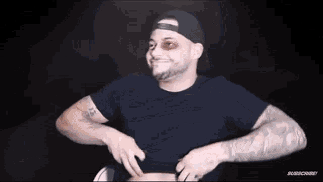 a man with a black eye and a tattoo on his arm is taking off his shirt .