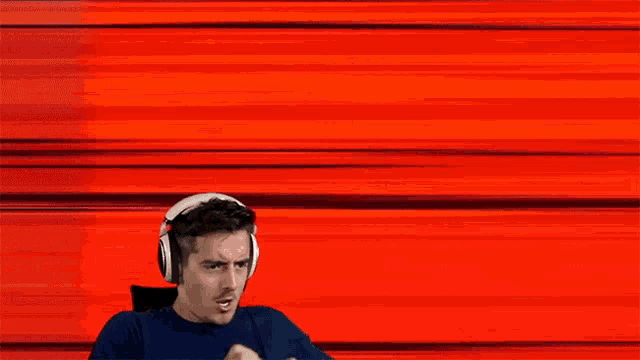 a man wearing headphones with a red background