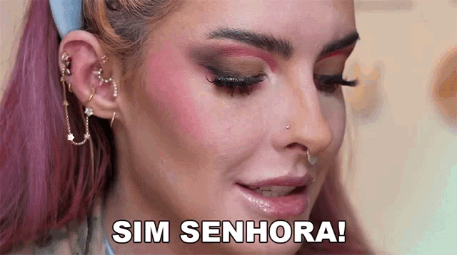 a close up of a woman 's face with the words sim senhora on the bottom