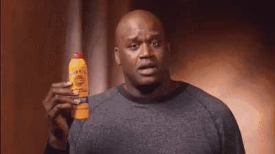 a bald man is holding a bottle of bug spray .