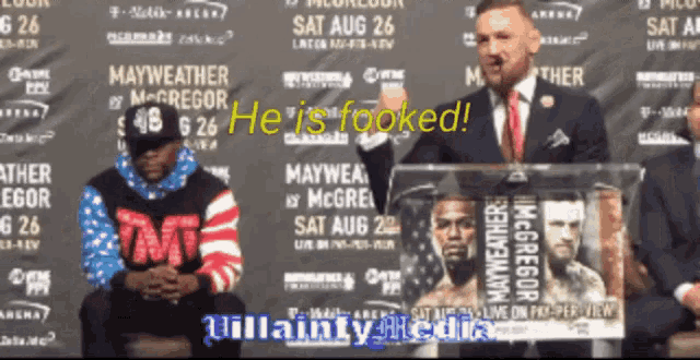 a man in a suit and tie stands in front of a podium that says " he is hooked "