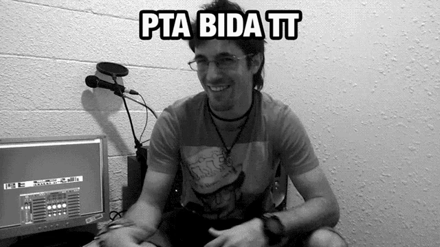 a man sitting in front of a computer with the words pta bida tt on the top