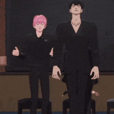 a man in a black suit is standing next to another man