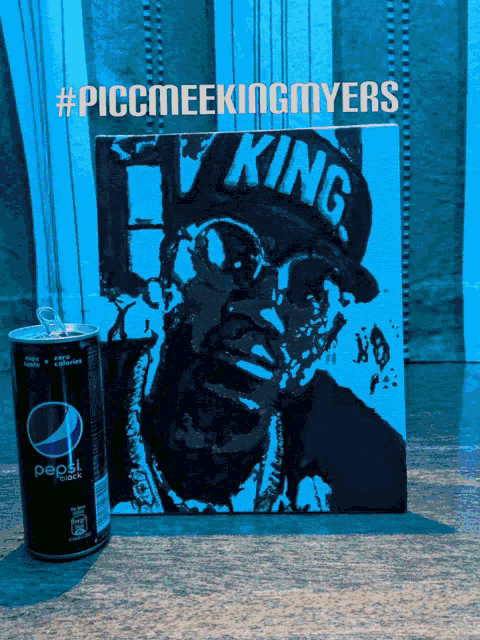 a can of pepsi sits next to a painting of a king