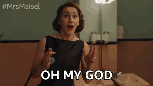 a woman in a black dress says oh my god in a bathroom