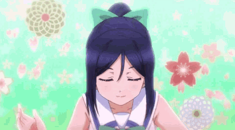 a girl with a ponytail is standing in front of a flower .