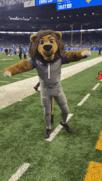 a mascot for the detroit lions is standing on a football field