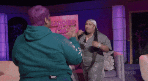two women are dancing in front of a sign that says ladies ' club