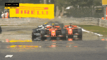 a yellow sign that says irelli is behind a group of race cars