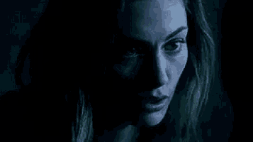 a close up of a woman 's face in the dark