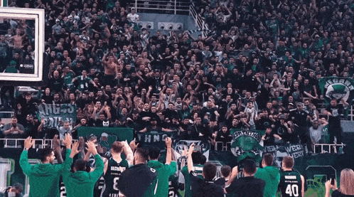 a crowd of people in a stadium with a banner that says " angels gate "