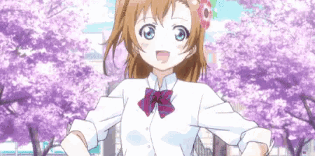 a girl in a school uniform with flowers in her hair is standing in front of a cherry blossom tree .