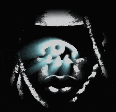 a pixelated image of a man 's face with a skull in the background