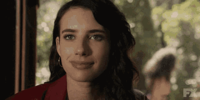 a close up of a woman 's face with the fx logo in the corner