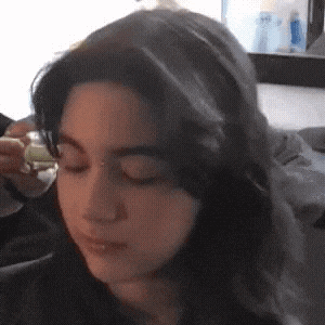a close up of a woman 's face with her eyes closed .