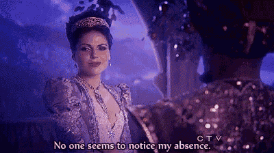 a woman in a purple dress with a tiara on her head is talking to a man .
