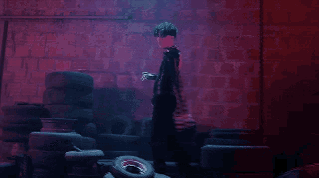 a man standing in front of a pile of tires in a dark room