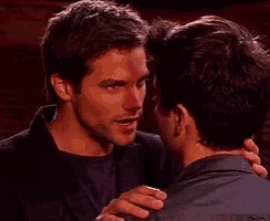 two men are hugging and looking into each others eyes