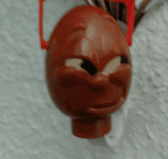 a close up of a toy head with red sunglasses on