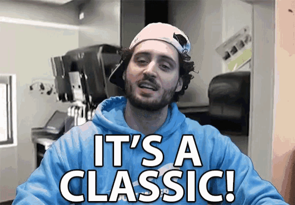 a man in a blue hoodie says it 's a classic while wearing a baseball cap