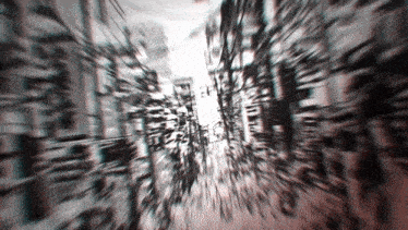 a blurred image of a city street with a few buildings
