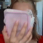 a woman covering her face with a pink cloth