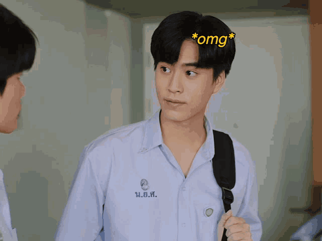 a boy in a white shirt has the word omg on his forehead