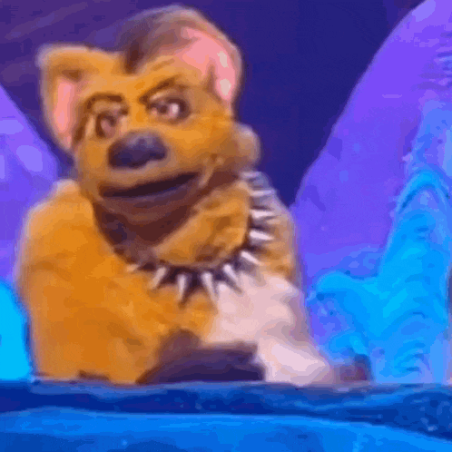 a cartoon dog wearing a spiked collar is sitting on top of a blue surface .
