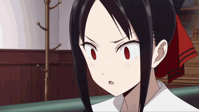 a girl with black hair and red eyes is looking at something