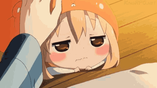 a person is putting their hand on a girl 's forehead