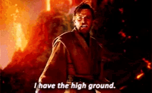 a man is standing in front of a fire and says `` i have the high ground . ''
