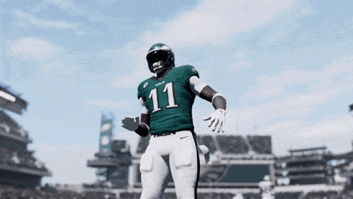 a football player with the number 11 on his jersey stands on a field
