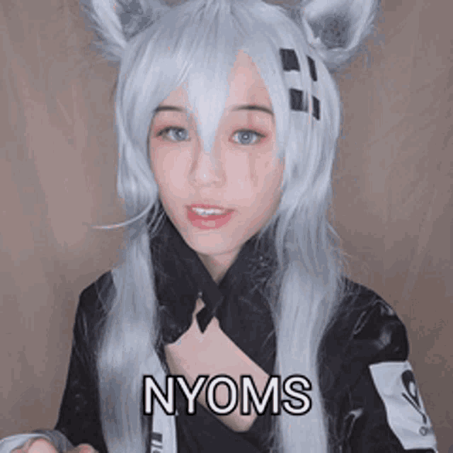 a woman wearing a cat costume has the word nyoms written on her chest
