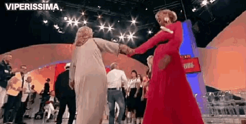 a group of people are dancing on a stage and the words viperissima are visible
